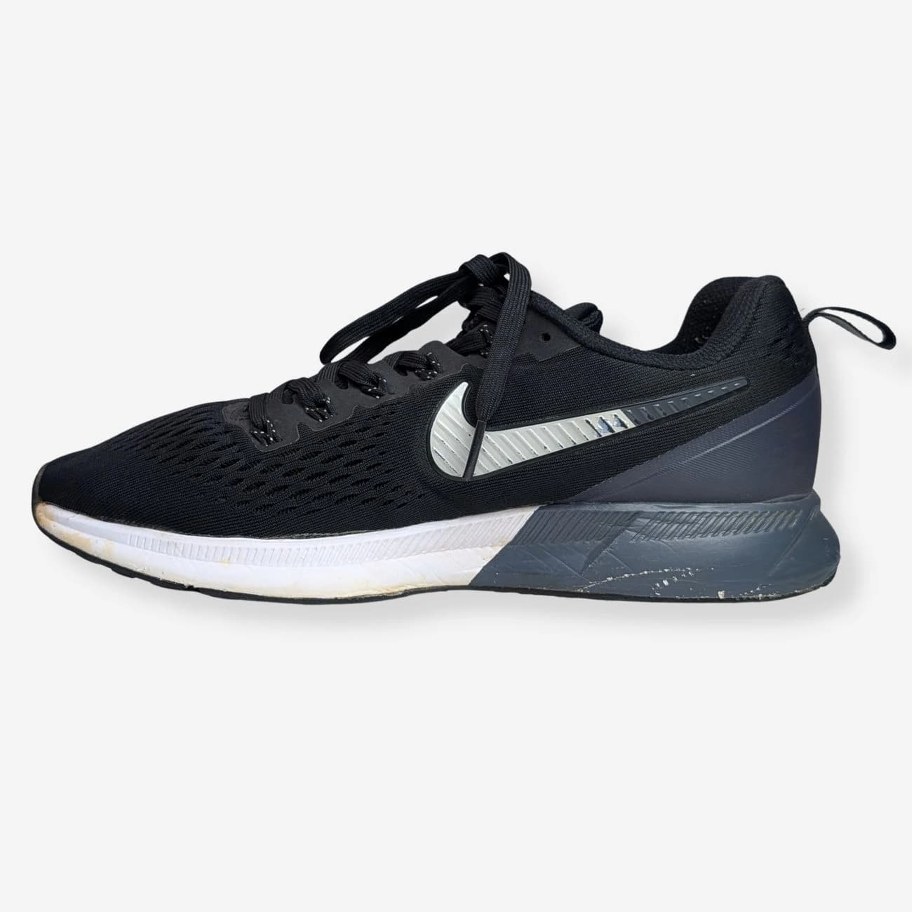 Nike Air Zoom Pegasus 34 running shoes in black and silver, featuring a breathable mesh upper, cushioned sole, and sleek design. Ideal for runners seeking comfort and style. Size and details not visible.