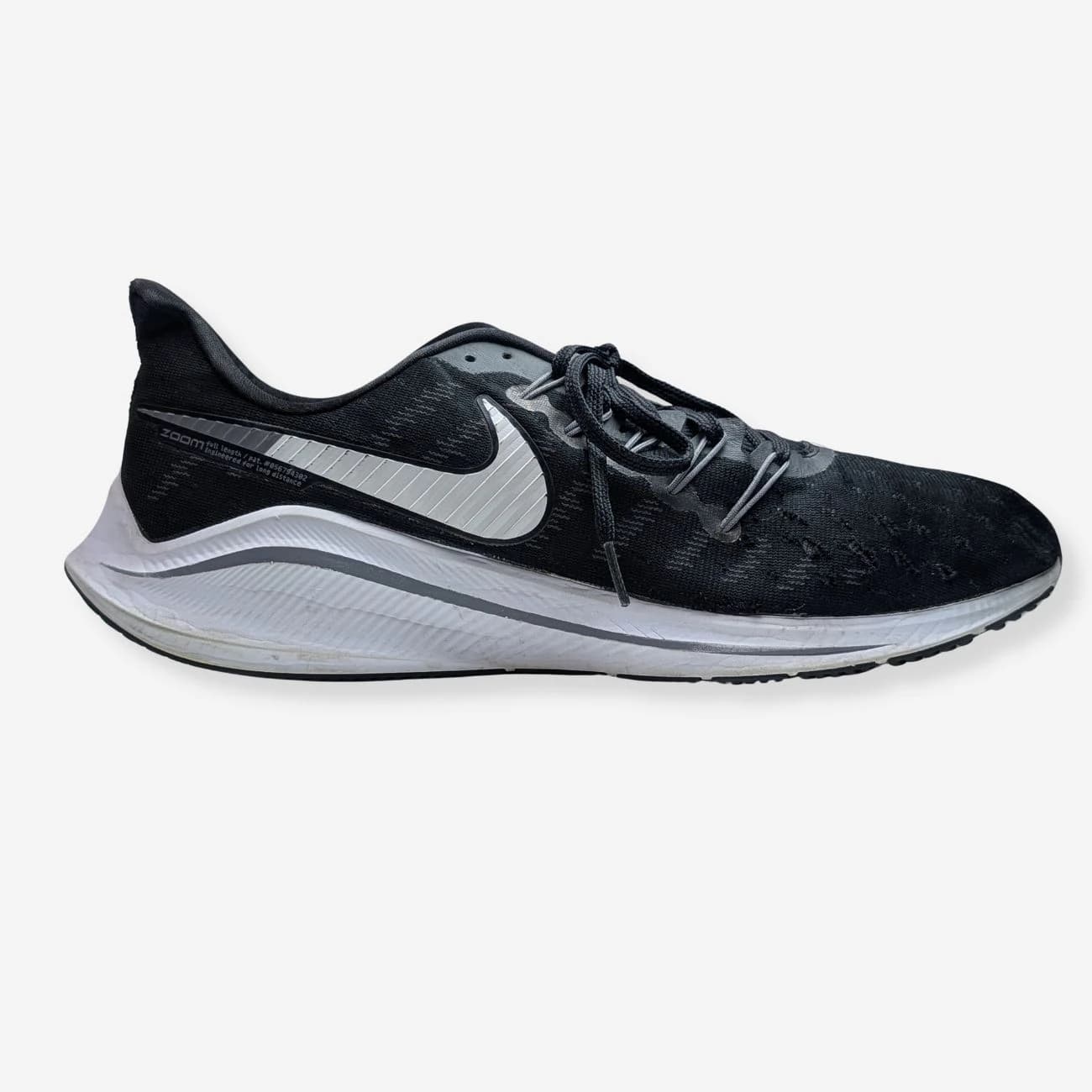 Nike Pegasus 34 running shoes in black and white, featuring a sleek design with a prominent Nike swoosh, lightweight mesh upper, and cushioned sole for optimal performance. Size and model details not visible.